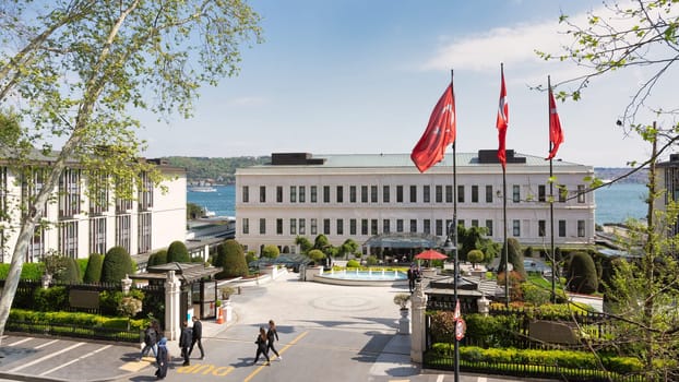 Istanbul, Turkey - May 8, 2023: View from Ciragan street of modern architectural design five stars Four Seasons hotel, suited by Bosphorus Strait, at Besiktas district, in a spring day