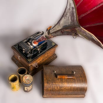 Cairo, Egypt - February 26 2016: High angle of 1911 Edison Fireside old phonograph with three cylinder records, on white background