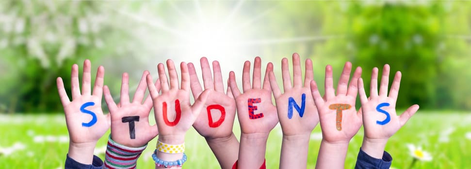 Children Hands Building Colorful English Word Students. Sunny Green Grass Meadow As Background.