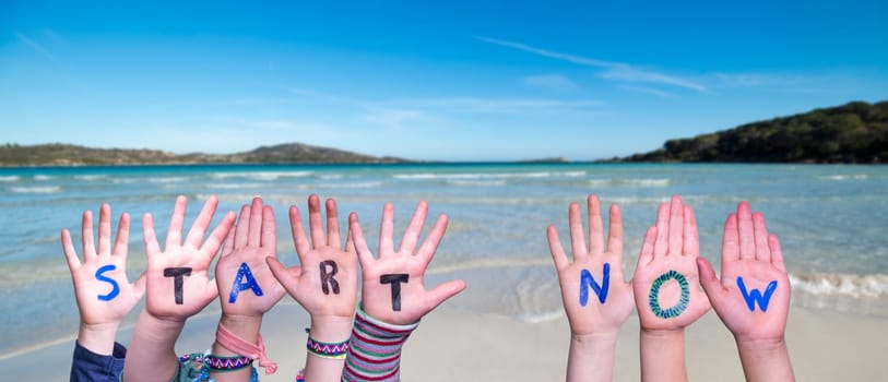 Children Hands Building Colorful English Word Start Now. Summer Ocean, Sea And Beach As Background.