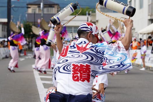KAGAWA, JAPAN - JULY 15 2023: Japanese performers dancing in the famous Awa-Odori Festival. Awa-Odori is a unique style of Japanese dance event.