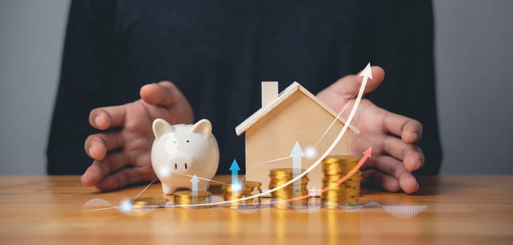 Stacked coins with piggy bank and chart graph showing savings growth. Businessman holding coins with the idea of saving money, budgeting, and investment for the future.