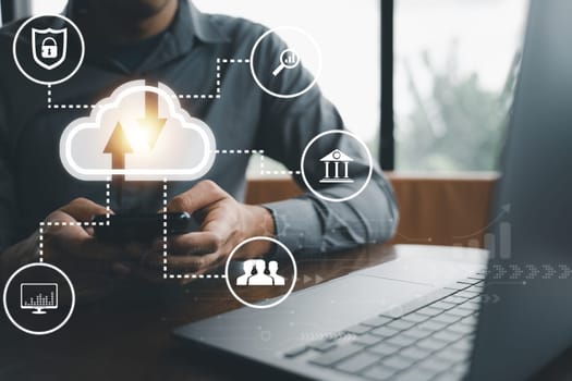 Man presenting cloud computing diagram on virtual screen. Cloud technology and data storage concept. Laptop and network server in the background is a symbol of internet service.