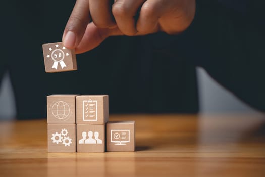 Quality control and assurance are represented by a hand placing wooden cubes with ISO icons on a table. An ISO banner in the background signifies certification and standardization
