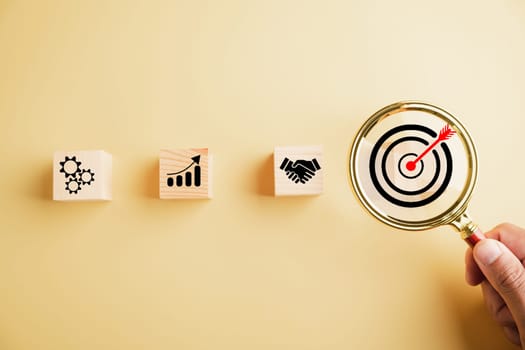 Target icon magnified through magnifying glass, highlighting connection to start-ups, creative ideas, and innovation. the concept of leadership, customer targeting, and motivation for success.