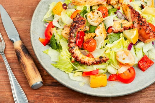 Salad of vegetables and octopus tentacles. Octopus salad. Top view