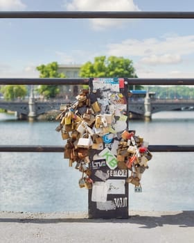 Stockholm, Sweden - June 26 2022: Love locks attached to the railing of Riksbron Bridge, or The National Bridge, Gamla Stan