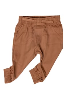 Clothes for newborn. Stylish brown baby pants or sweatpants isolated on white background. Clipping path. Baby clothes. Kids trousers.