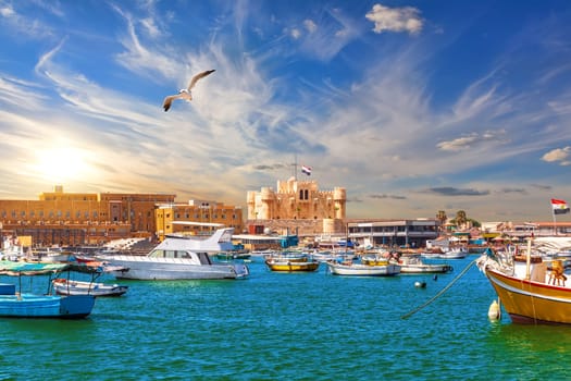 Harbour and boats in Alexandria near Qaitbay Citadel, famous view of Egypt.