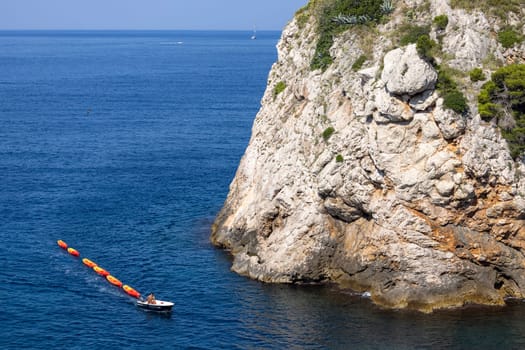 Dubrovnik, Croatia - June 27, 2023: Transportation of colorful kayaks for tourists by water on the Adriatic Sea to the West Harbour next to Fort Lovrijenac and City Walls