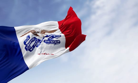 Iowa state flag waving in the wind on a clear day. Three vertical stripes of blue, white, and red, with a bald eagle in the center. 3d illustration render. Textured fabric background