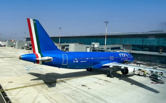 Rome, IT, July 13 2023: Airbus A320neo airplane operated by ITA Airways parked at the boarding area of Fiumicino Airport. Illustrative editorial. Transportation and travel