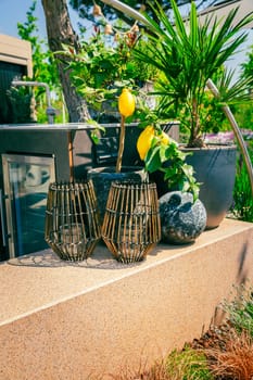 Outdoor kitchen in a garden or terrace with plants and decoration and lantern
