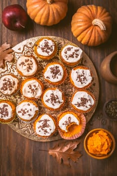 Spicy pumpkin muffins or cupcakes with cream cheese frosting