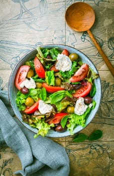 Burrata, Italian fresh cheese made from cream and milk of buffalo or cow. Burrata salad with tomatoes and salad mix. Healthy eating concept, keto diet salad