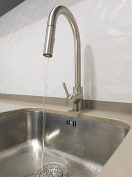Open kitchen sink tap. Selective focus