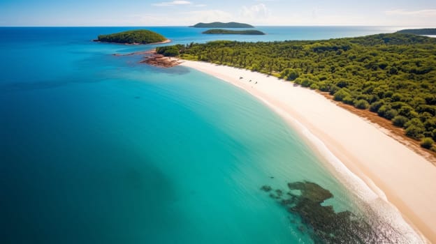 An aerial view of a sandy beach and blue water