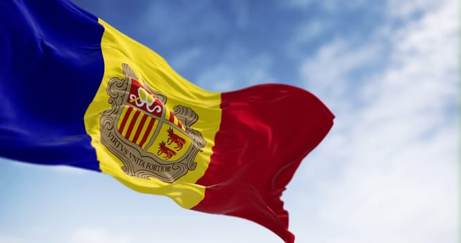 The flag of the Principality of Andorra waving in the wind on a clear day. Vertical blue-yellow-red stripes with coat of arms in center. 3d illustration render. Rippled fabric.