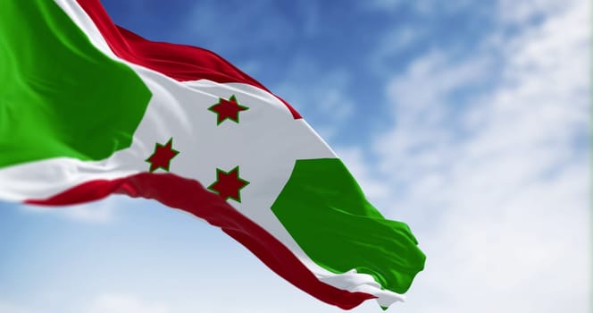 National flag of Burundi waving on a clear day. White diagonal cross dividing into red and green sections, three green stars in the center. 3d illustration render. Fluttering fabric. Selective focus