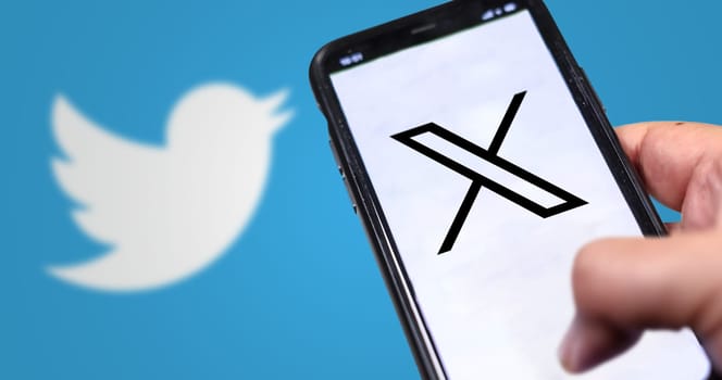 San Francisco, US, July 23 2023: hand holding a mobile phone with the new X logo on the screen. On July 24, 2023, Twitter changed its logo from the blue bird to the X symbol. Illustrative editorial