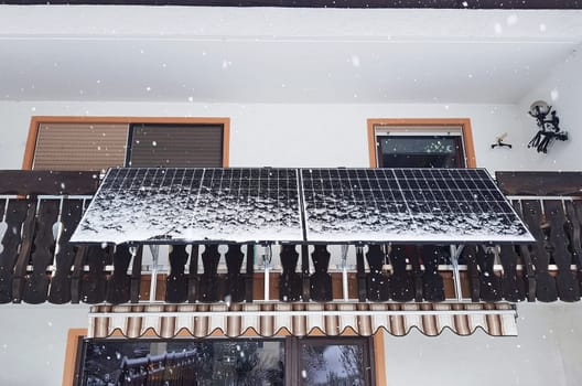 A balcony power plant in winter. Solar panels to generate electricity in the snow on a balcony.