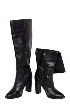 A pair of black elegant female boots or woman shoes isolated on a white background. Leather boots.