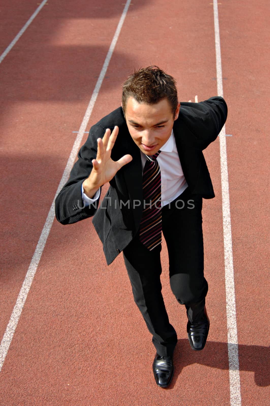 Man running on a track & field complex