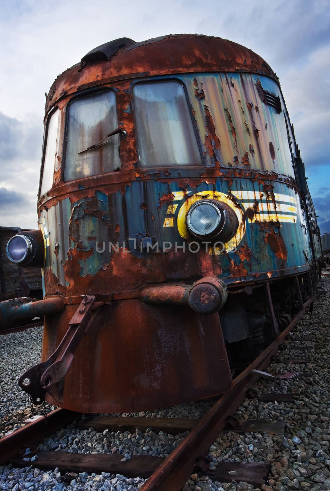 old broken rusty locomotive still on rails