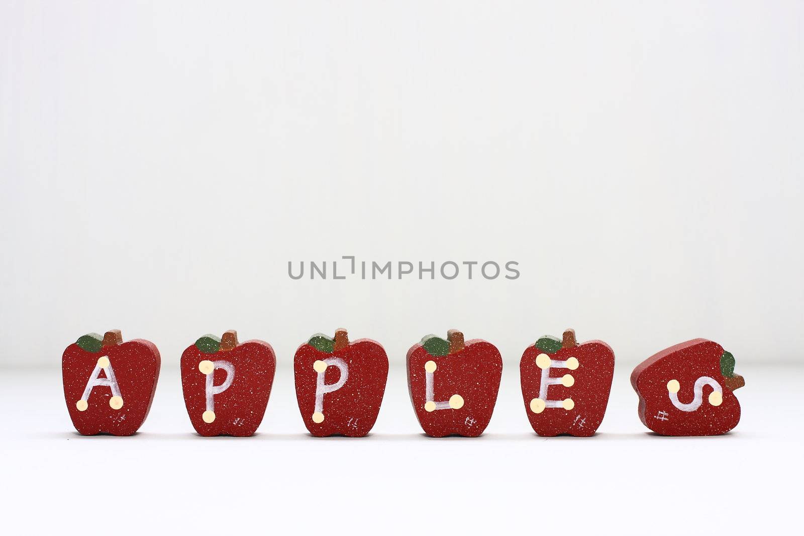 Wooden Apples with letterings spelling "apples."