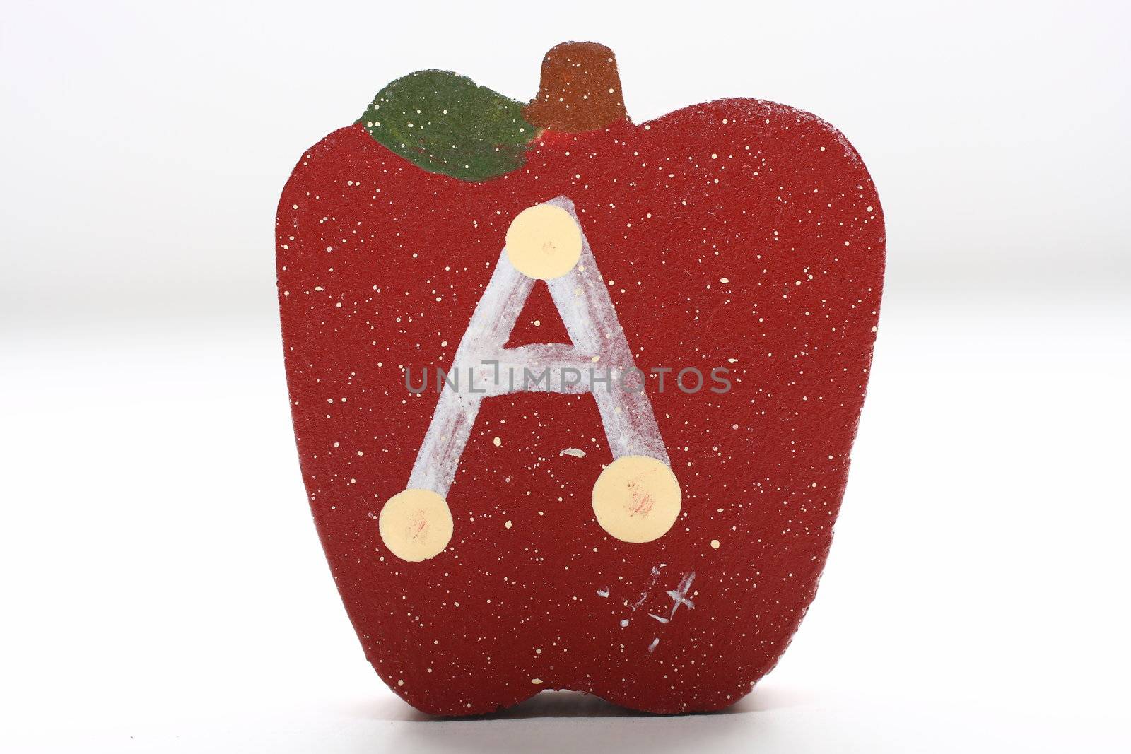 Wooden Apples with the letter "A" painted on it.