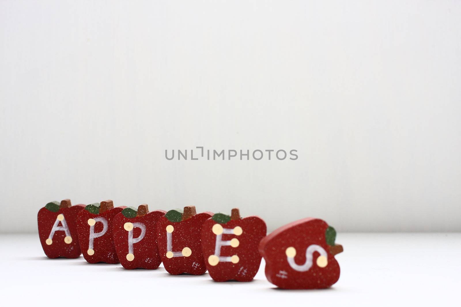 Wooden Apples with letterings spelling "apples."