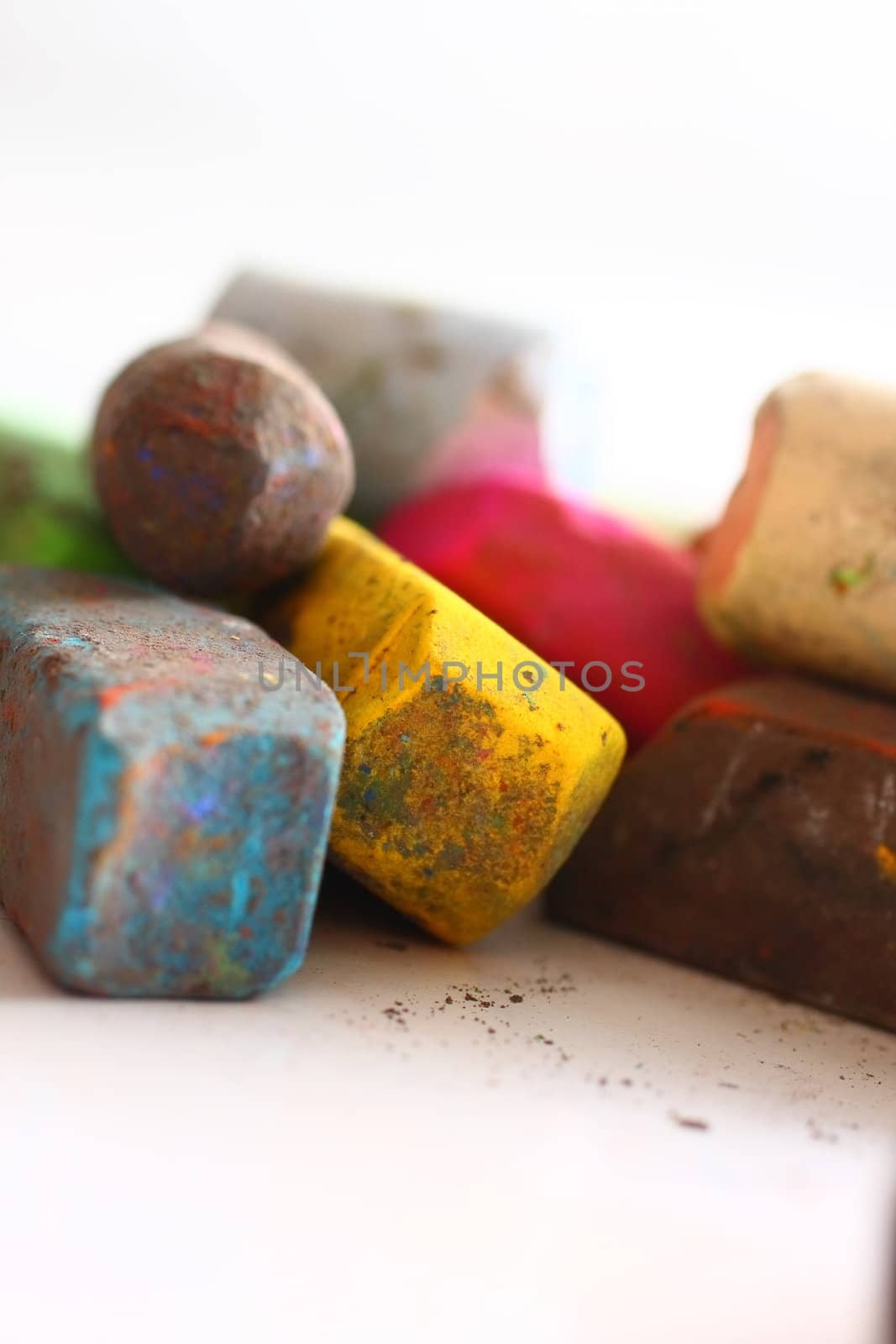 A few used colored chalk pastels on white