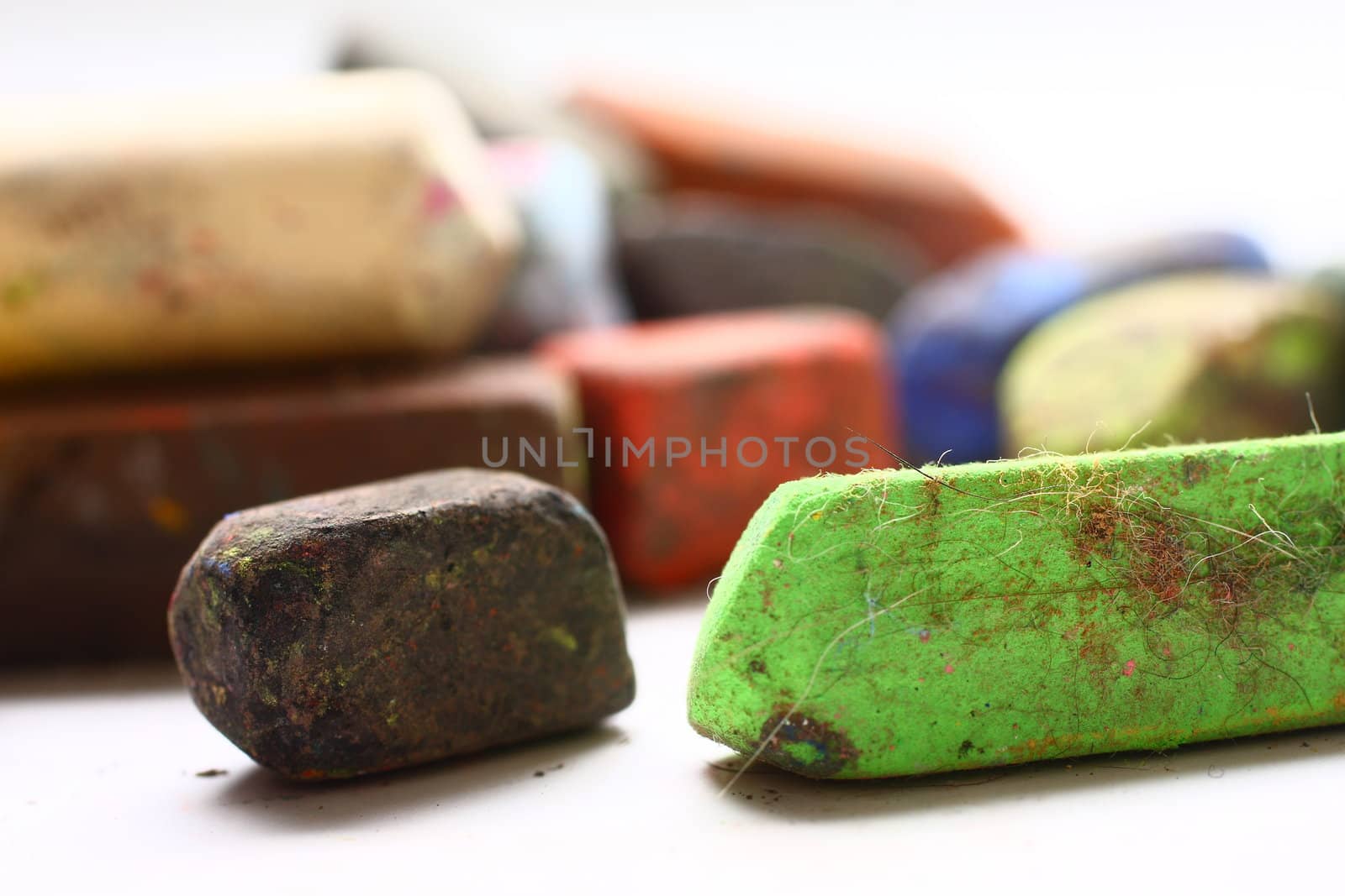 A few used colored chalk pastels on white