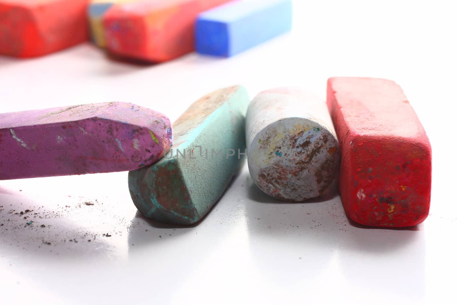 A few used colored chalk pastels on white