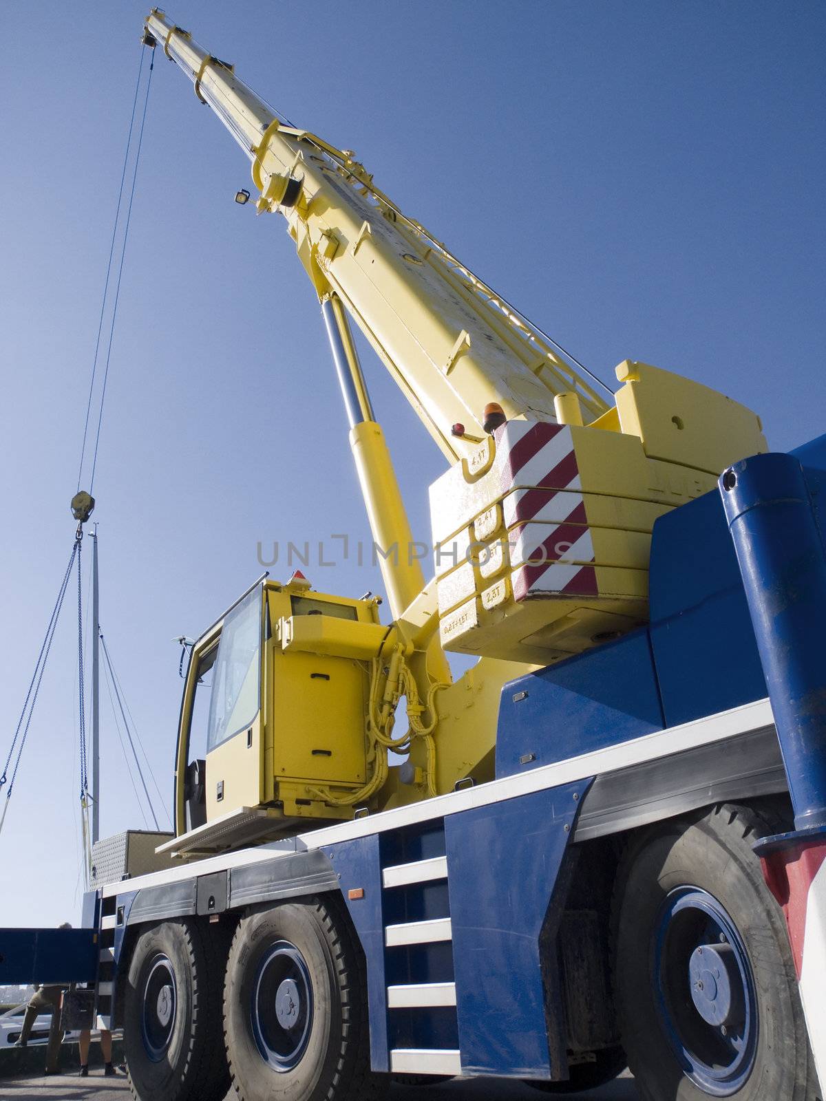 Autocrane unloading against a blue sky