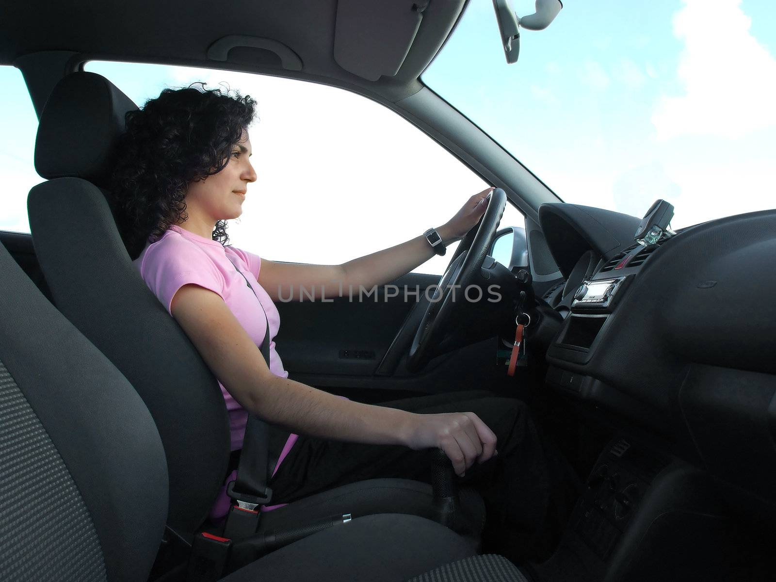 Woman driving car with detail of interior car