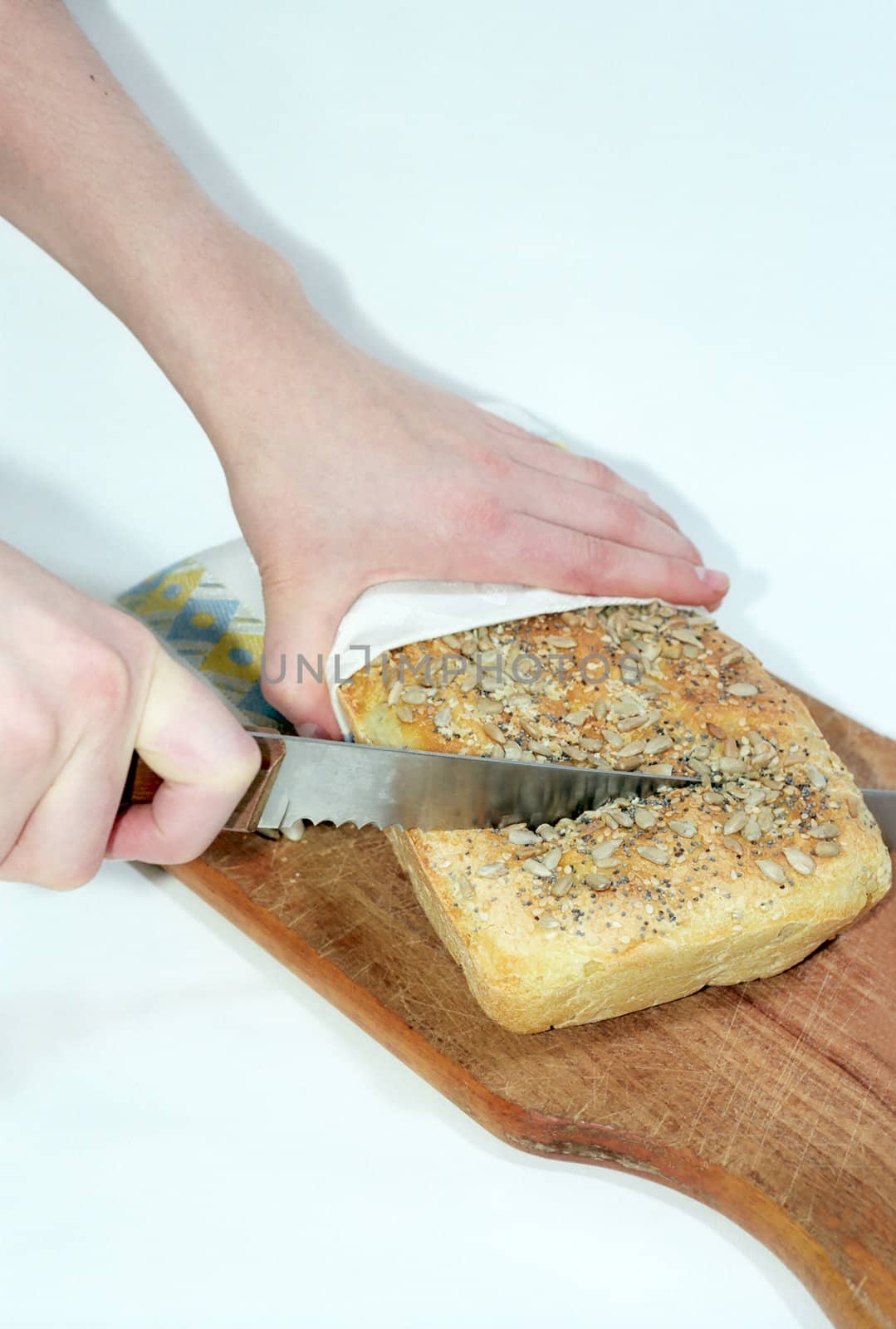 Bread cutting on wooden breadboard
