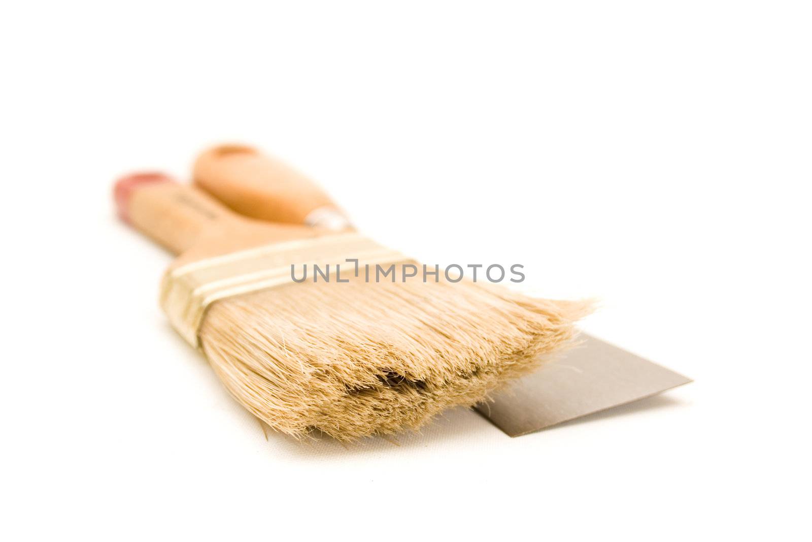 Paintbrush and putty knife isolated on white background