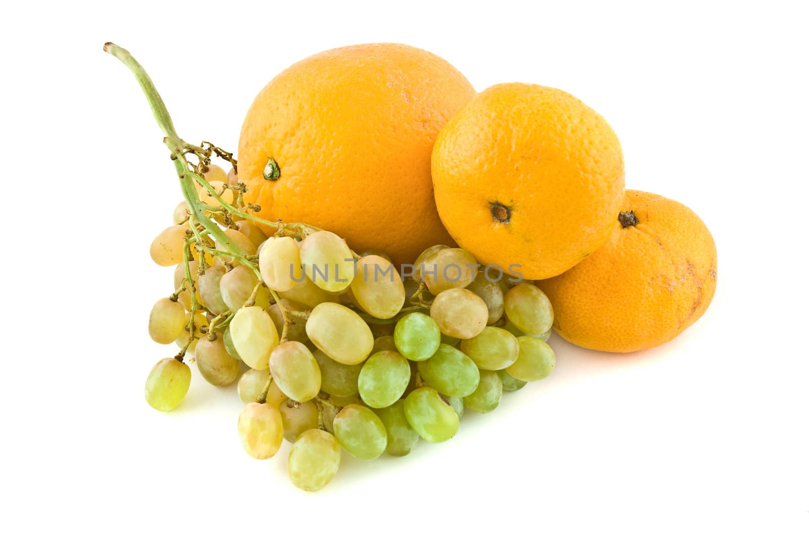 Fresh grapes with orange and tangerines, isolated on white