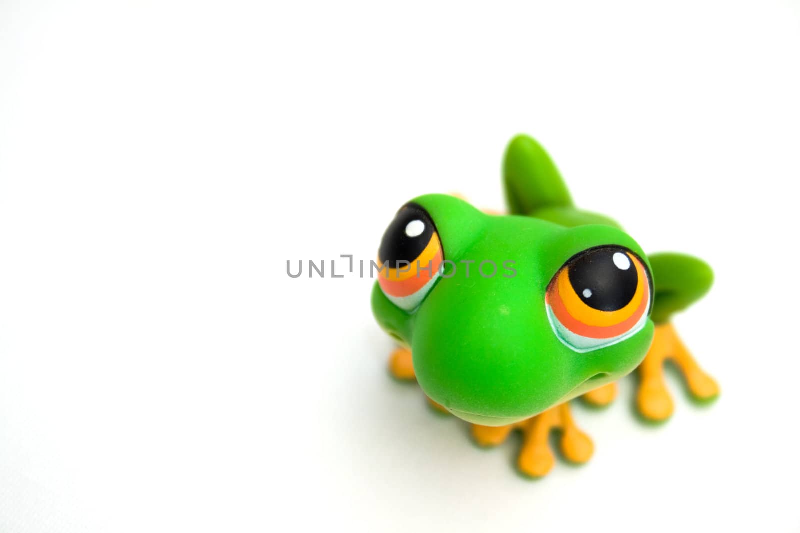 Green frog toy isolated on white background.