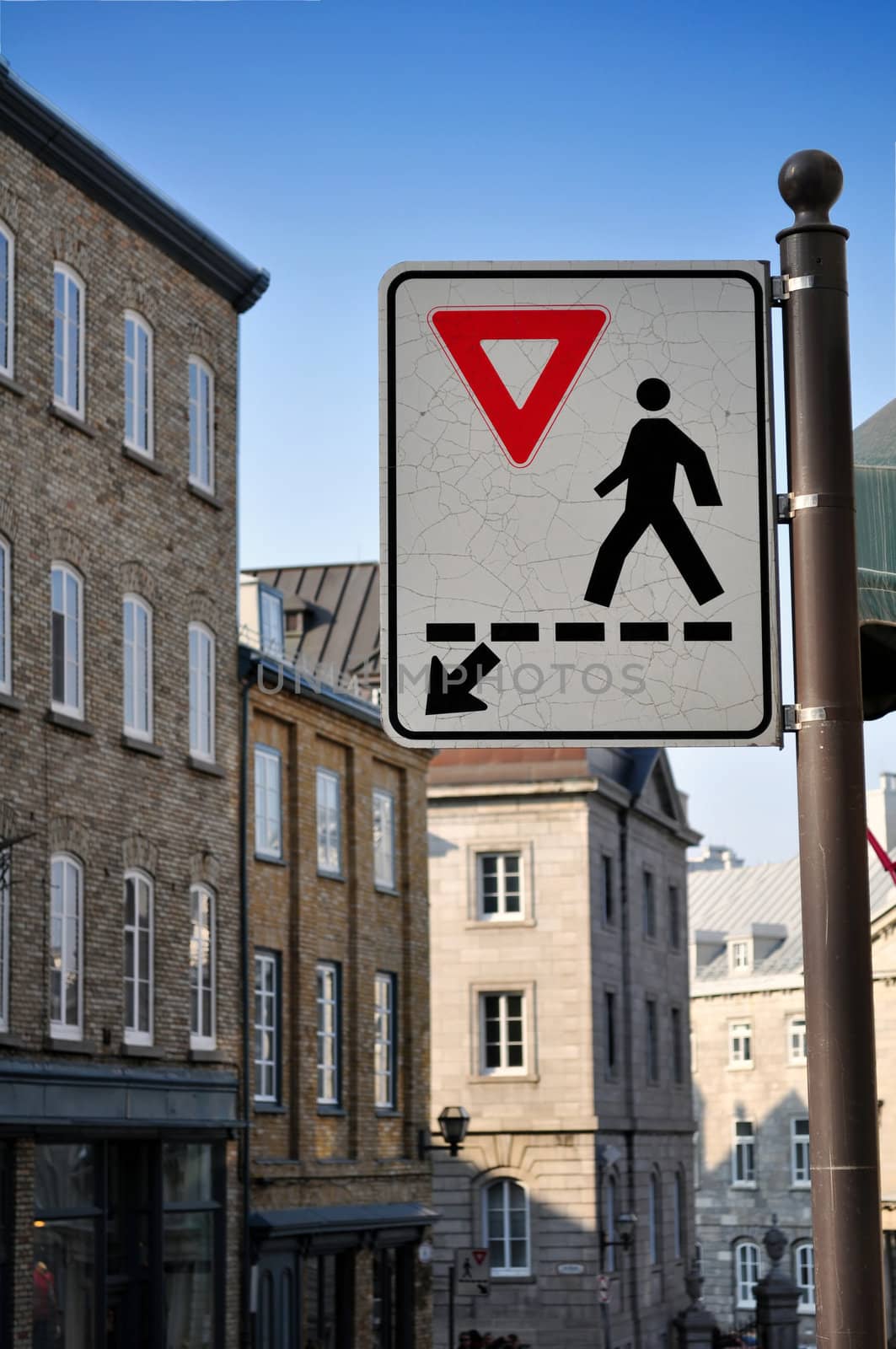 Give way, cross here. Pedestrians crossing sign