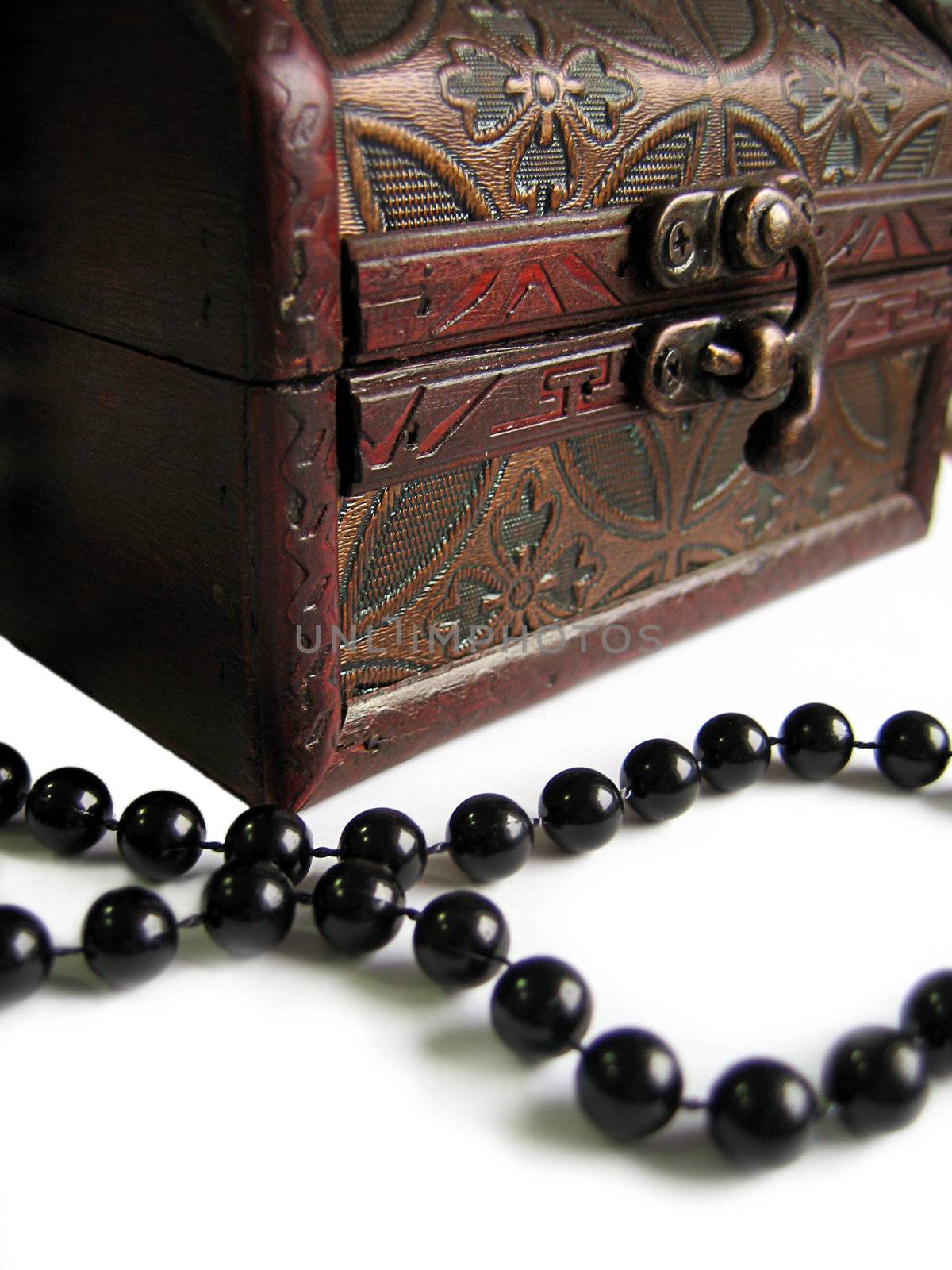Old-fashioned ornate chest box with black pearls