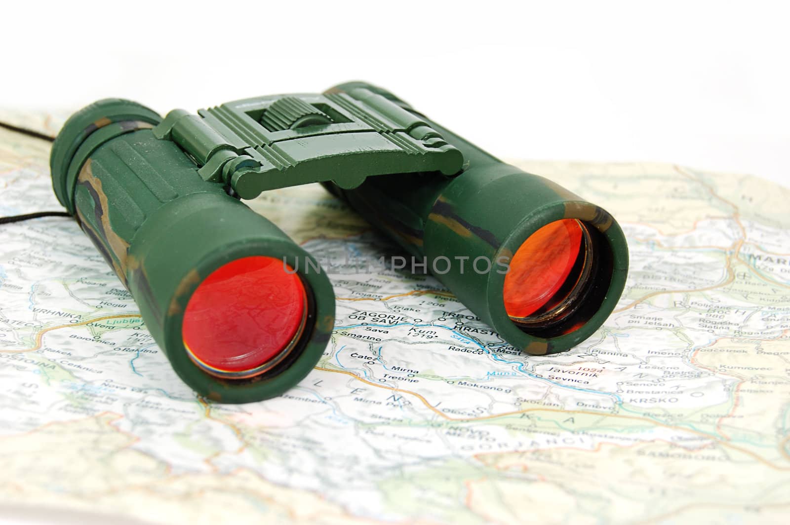 military binoculars positioned on map