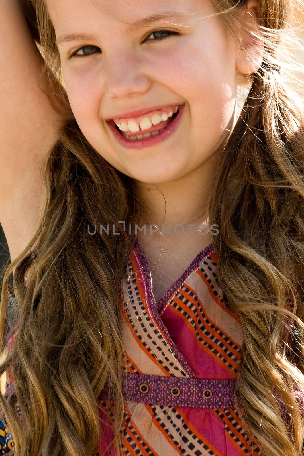 Young girl is smiling while playing on the playground