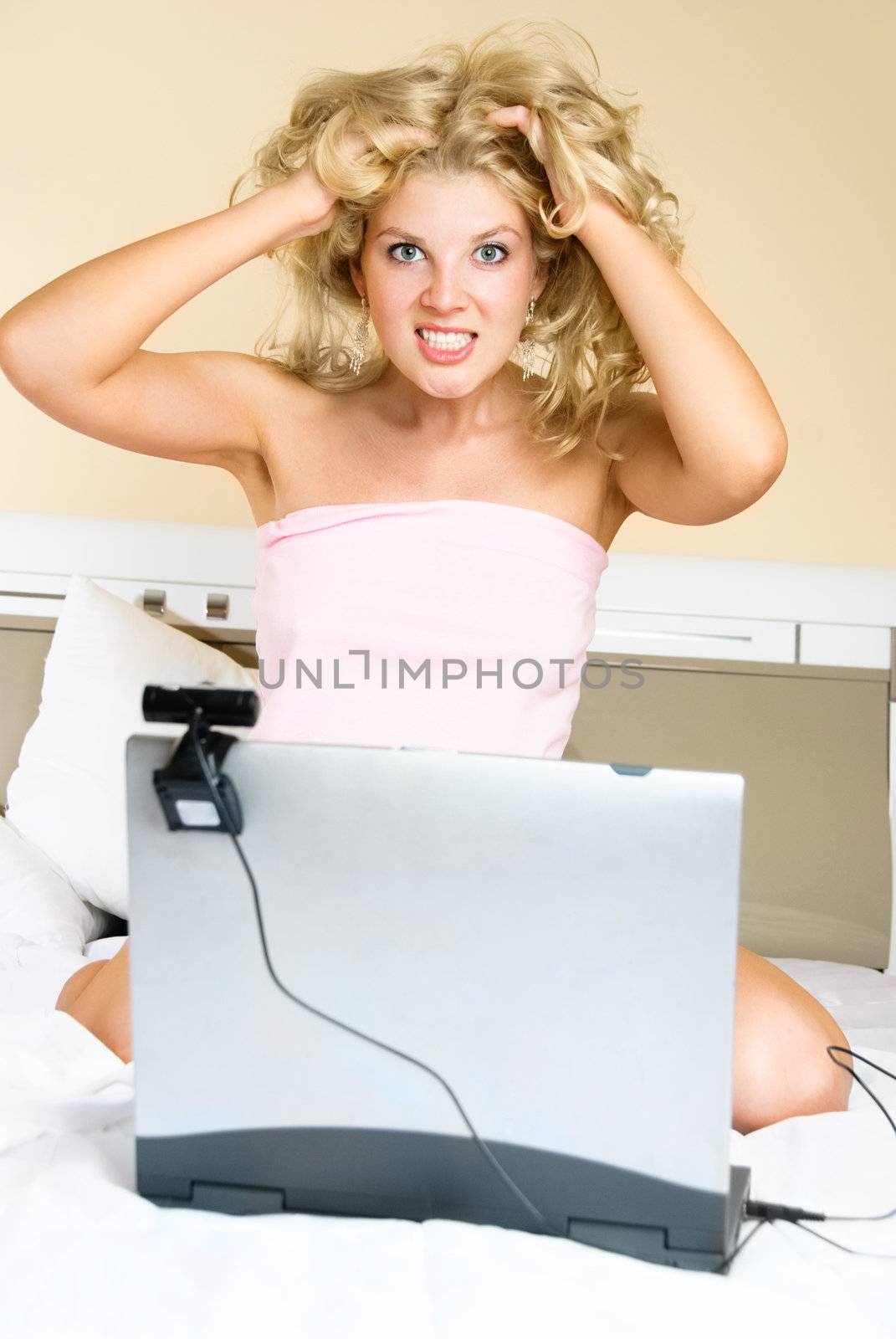 shocked girl at home communicating through the Internet using a web camera 