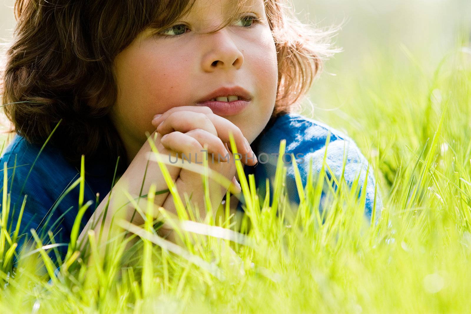 young boy is looking up in the sky