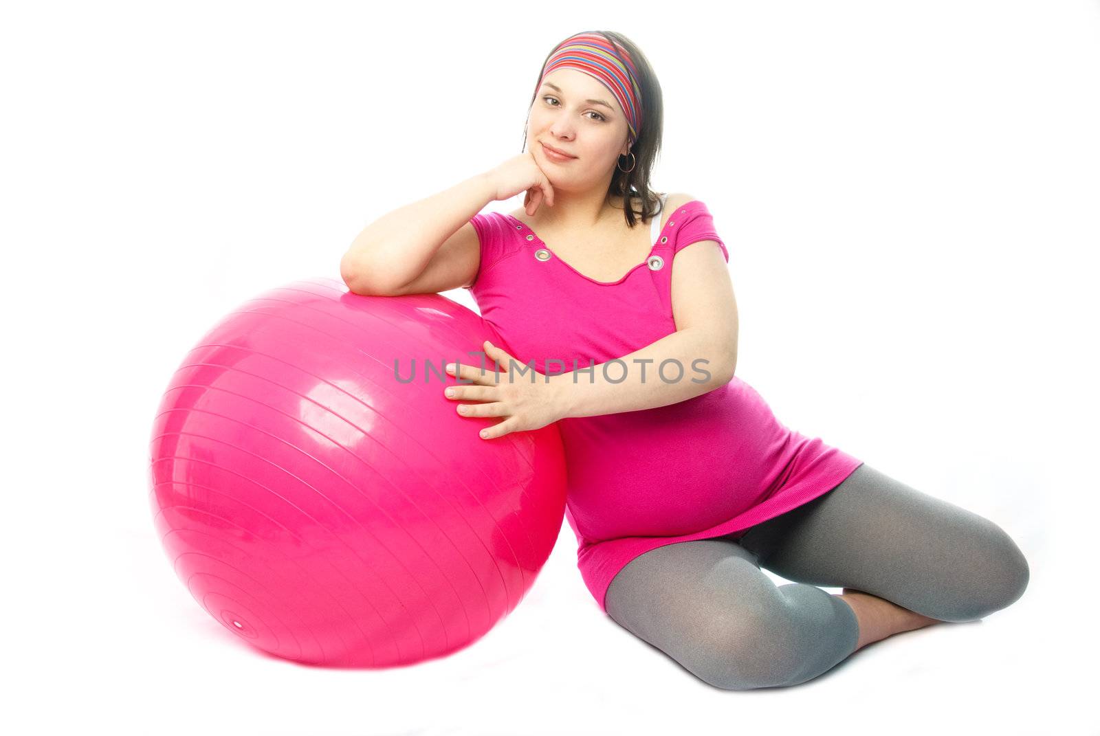 beautiful pregnant woman making some exercises on a fitness ball