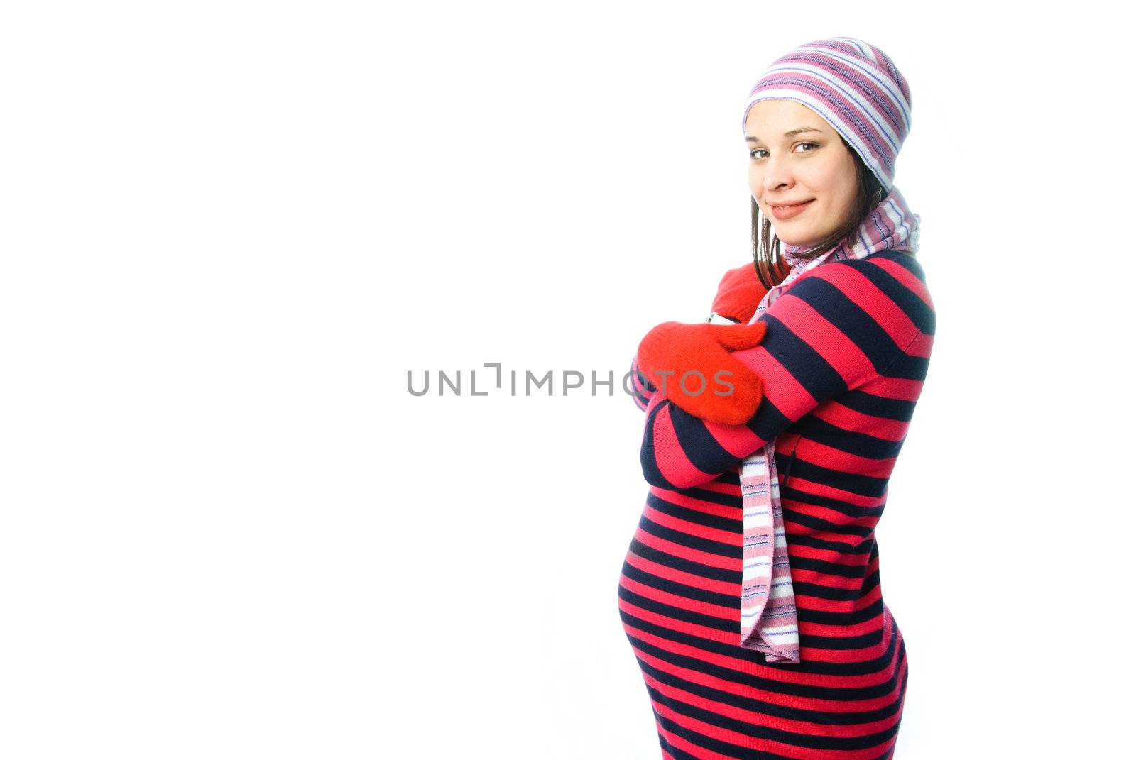 beautiful young pregnant woman wearing warm winter clothes against white background