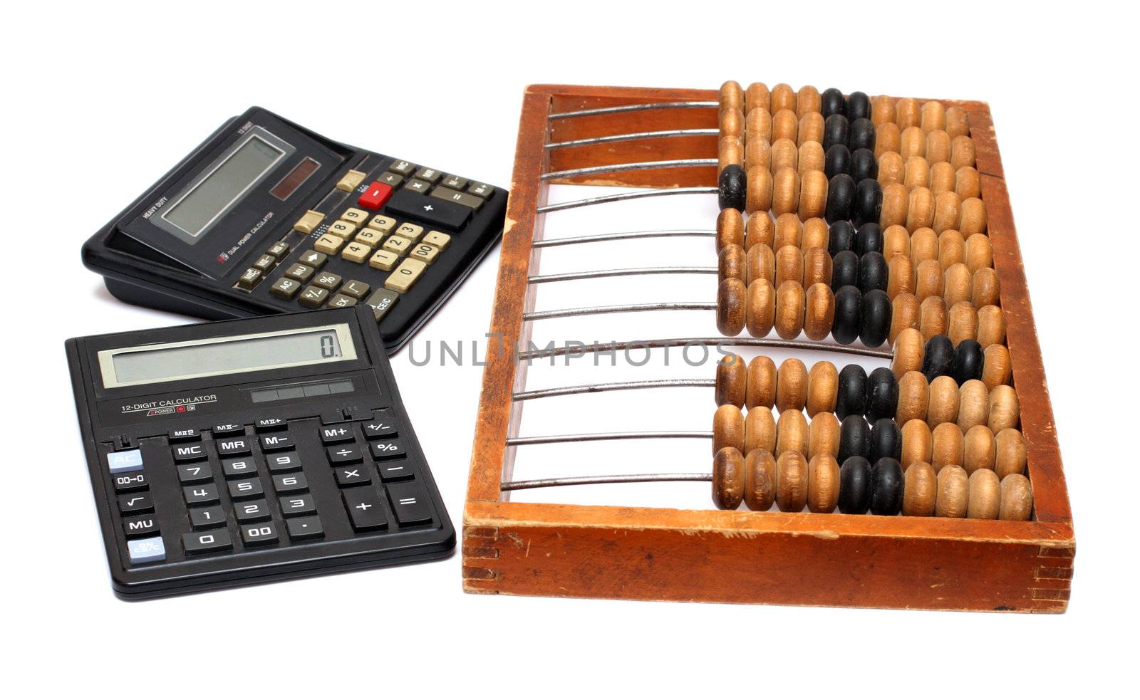 old wooden abacus and two electronic calculators
