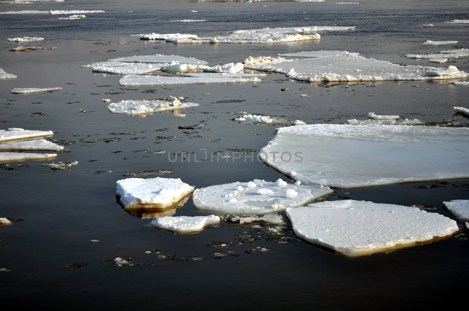 Winter scenery, ice blocks floating on river.